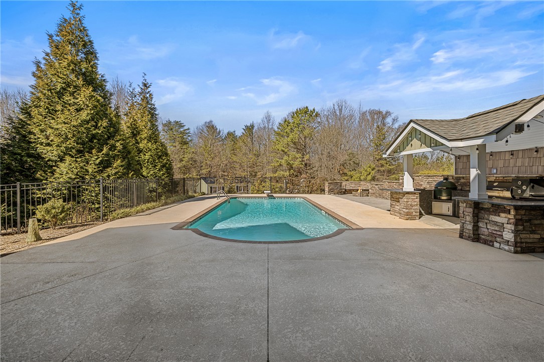 209 Crestridge Drive Seneca, SC 29672 - Photo 40 of 49 This private outdoor retreat features a sparkling pool and a fully equipped outdoor kitchen for memorable gatherings.