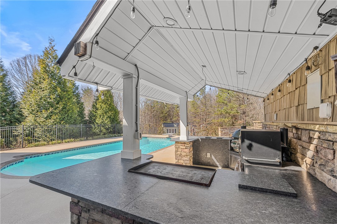 209 Crestridge Drive Seneca, SC 29672 - Photo 42 of 49 Enjoy outdoor gatherings with this covered patio, complete with a grill area and a refreshing pool.