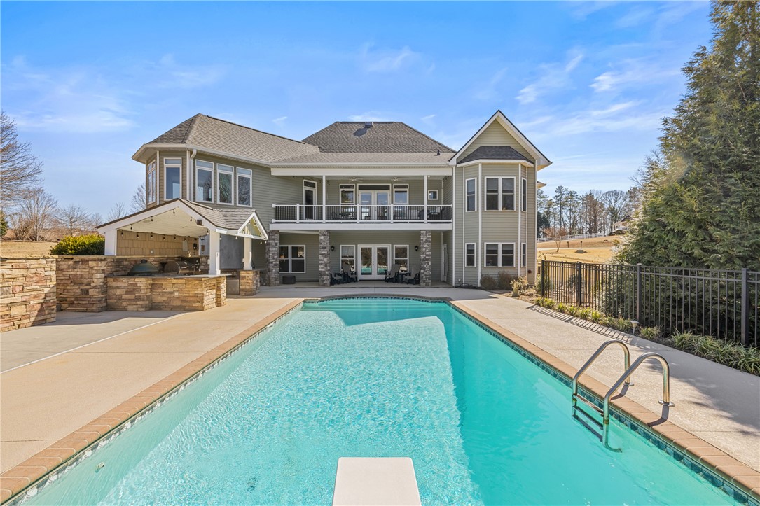 209 Crestridge Drive Seneca, SC 29672 - Photo 44 of 49 This exquisite property features a large pool and an expansive outdoor kitchen, perfect for entertaining.