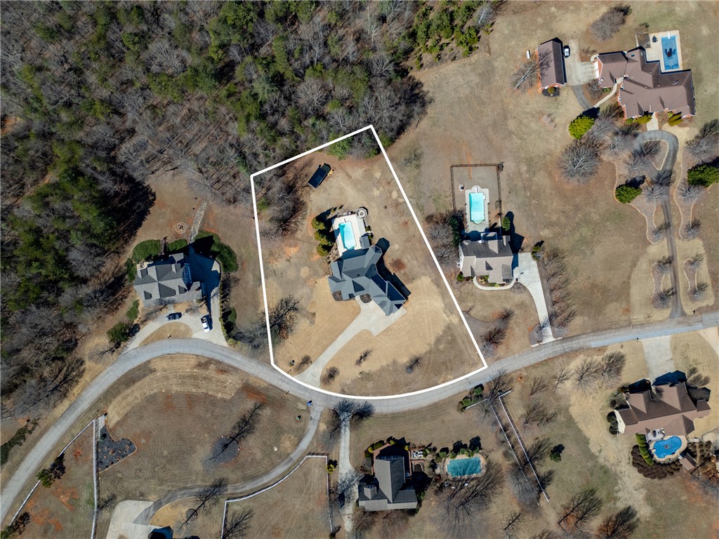 209 Crestridge Drive Seneca, SC 29672 - Photo 46 of 49 An aerial view captures the property's expansive grounds, showcasing a private pool and surrounding homes.