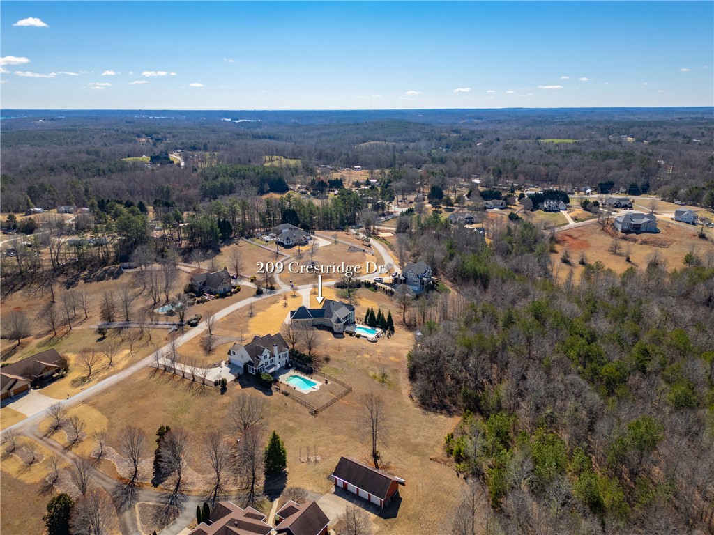 209 Crestridge Drive Seneca, SC 29672 - Photo 47 of 49 Perched on a sprawling lot, this estate features a refreshing pool amidst mature trees and scenic views.