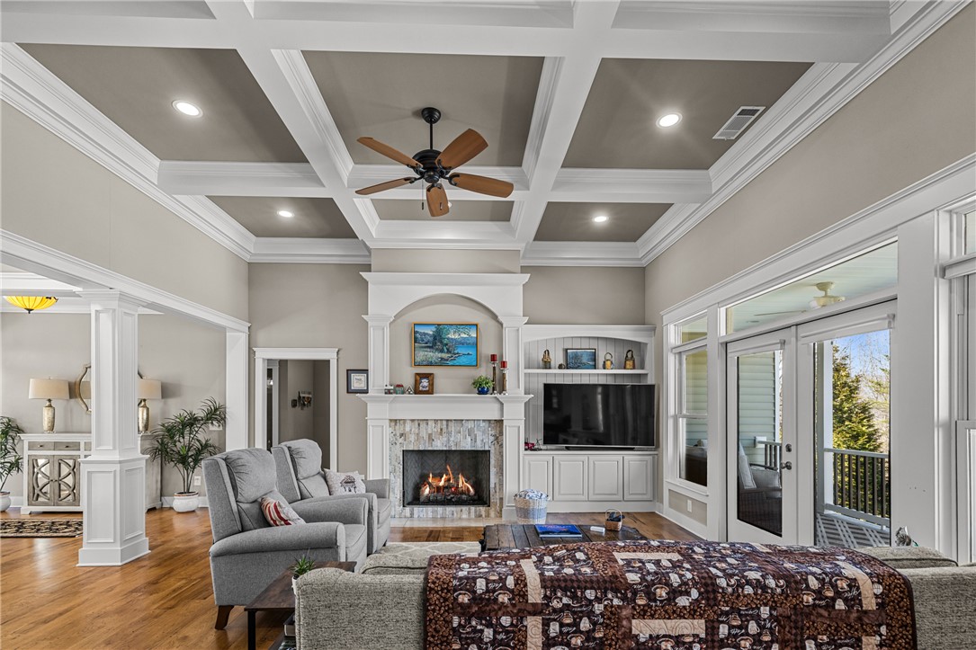 209 Crestridge Drive Seneca, SC 29672 - Photo 6 of 49 This living area features rich hardwood floors, an inviting fireplace, and a coffered ceiling.