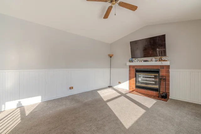 a view of an empty room with a kitchen