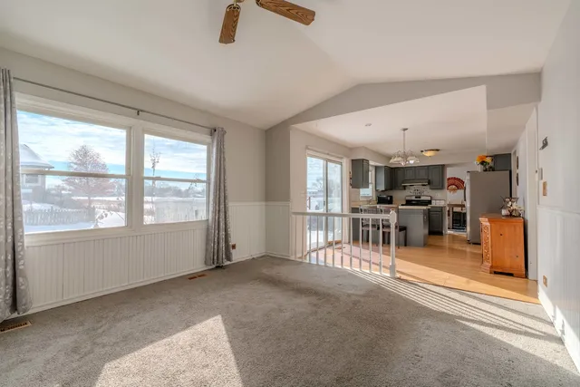 a view of a livingroom with furniture and a window