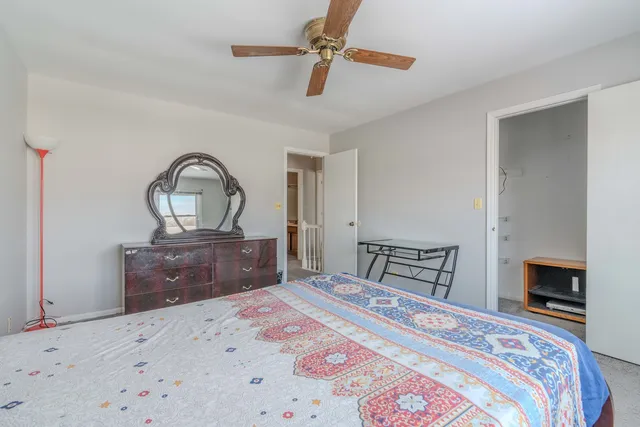 a bedroom with a bed dresser and a dresser