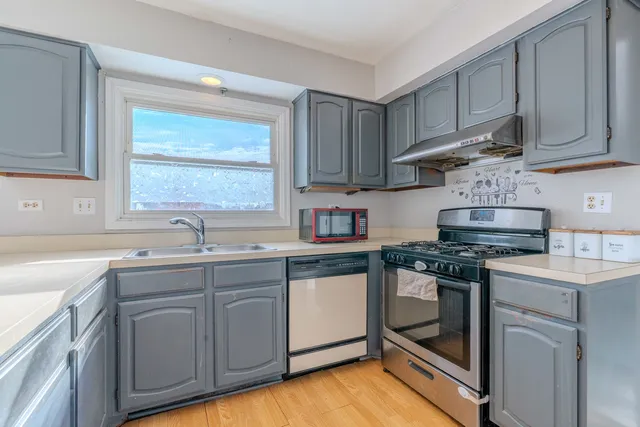 a kitchen with cabinets appliances and a sink