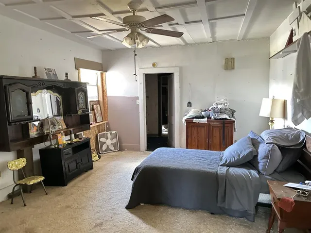 a bedroom with a bed and gym equipment