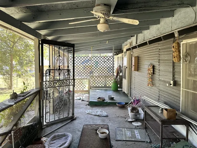 a view of a house with a yard and large trees