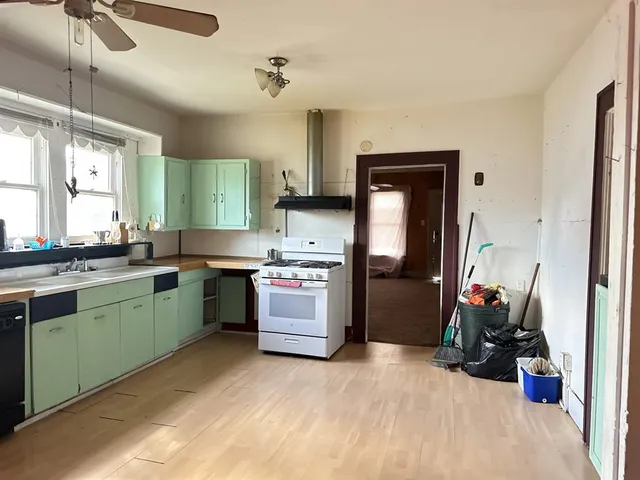 a kitchen with a sink cabinets and window