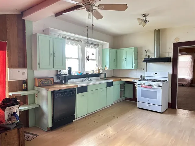 a kitchen that has a sink and a stove in it