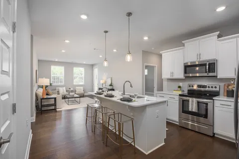 a kitchen with a sink appliances and cabinets