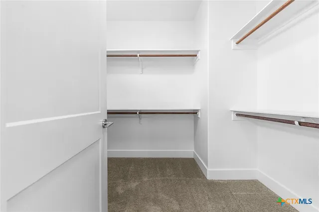 a bathroom with a tub double sink shower and mirror