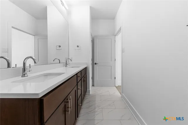 a spacious bedroom with a bed and a flat screen tv