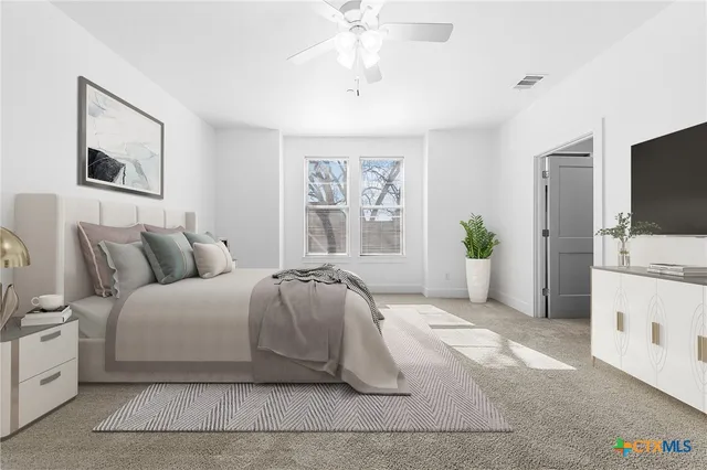 a living room with furniture and a view of kitchen