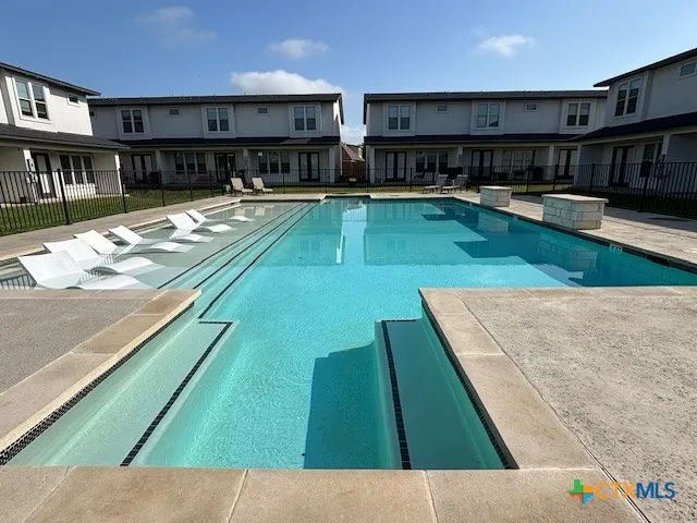 a view of a house with swimming pool and sitting area