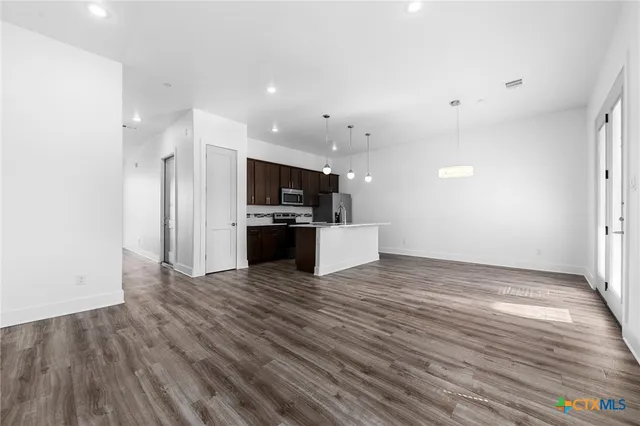 a view of a kitchen with a sink and a stove top oven
