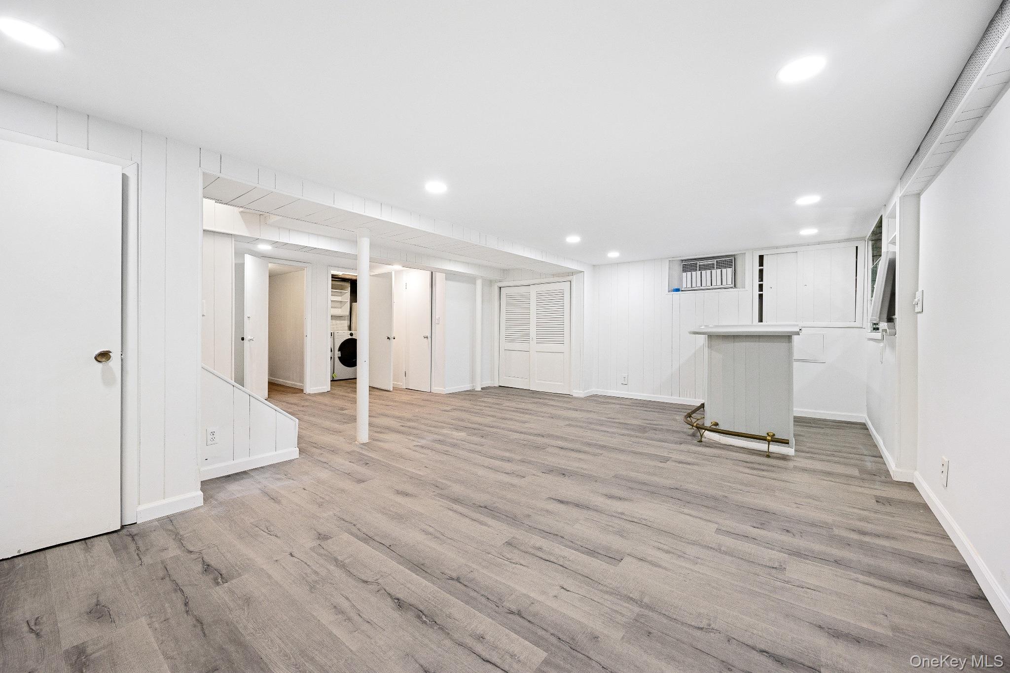10 River Road Scarsdale, NY 10583 - Photo 20 of 20 Finished below grade area with recessed lighting, light wood-style flooring, and washer / dryer
