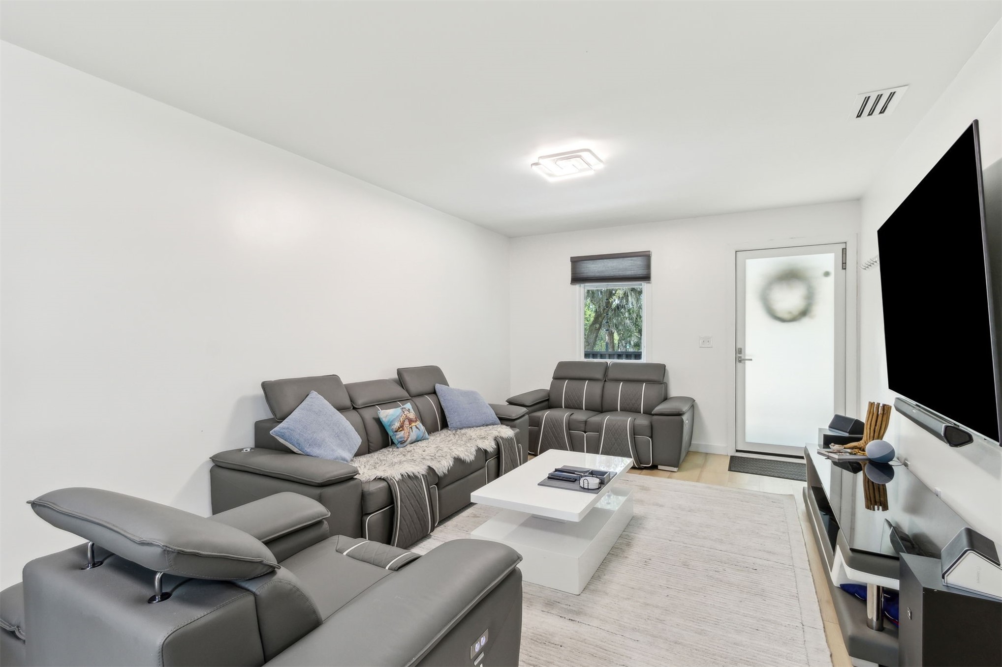 724 North 14th Street Fernandina Beach, FL 32034 - Photo 12 of 34 a living room with furniture and a flat screen tv