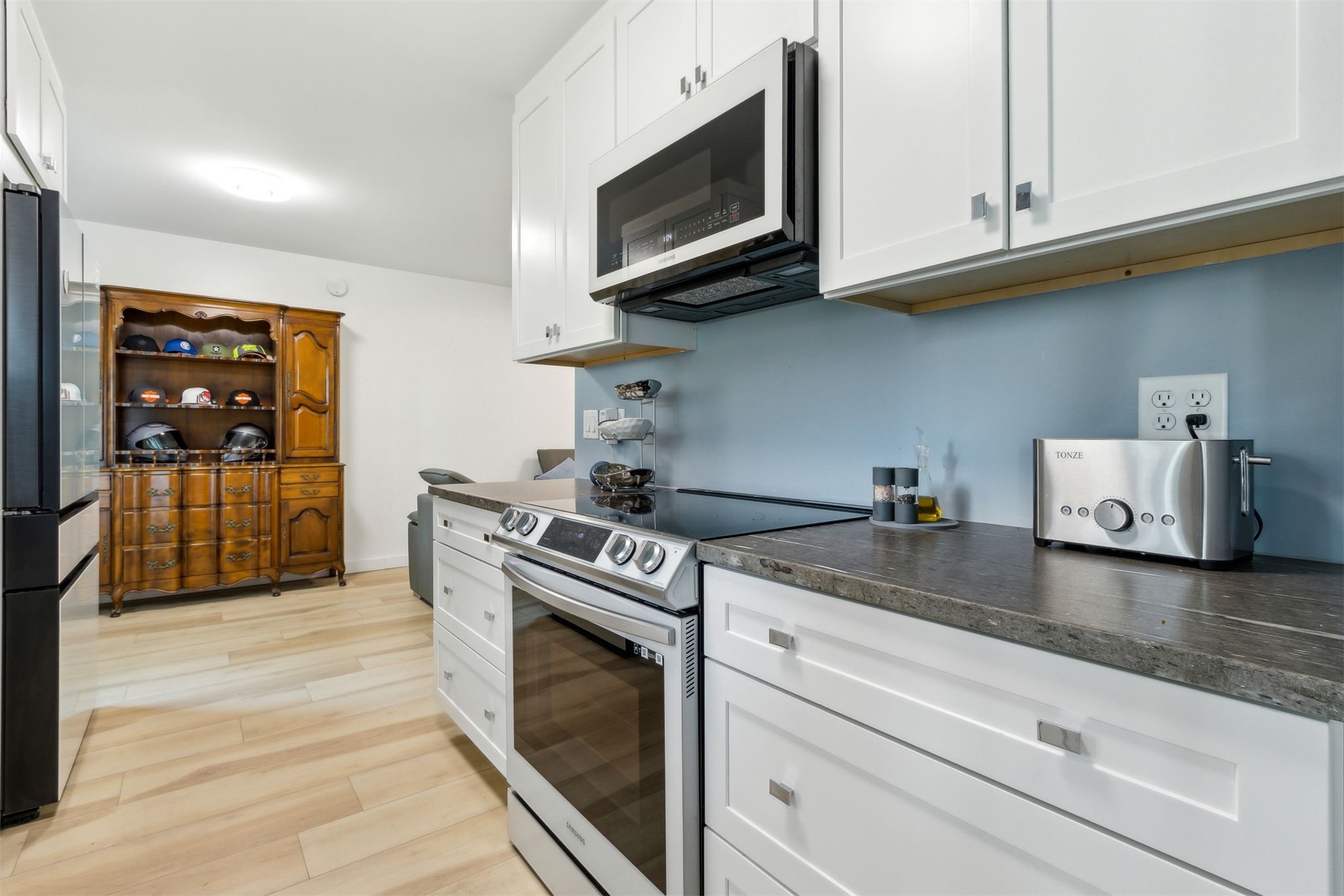 724 North 14th Street Fernandina Beach, FL 32034 - Photo 17 of 34 a kitchen with granite countertop a stove top oven microwave and cabinets