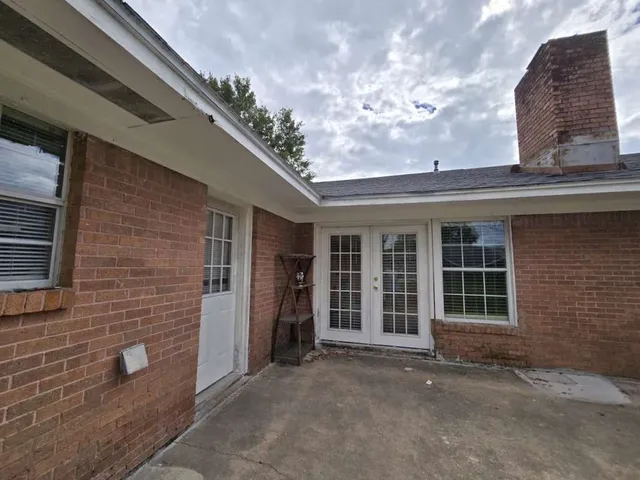 a view of a brick house with a large windows