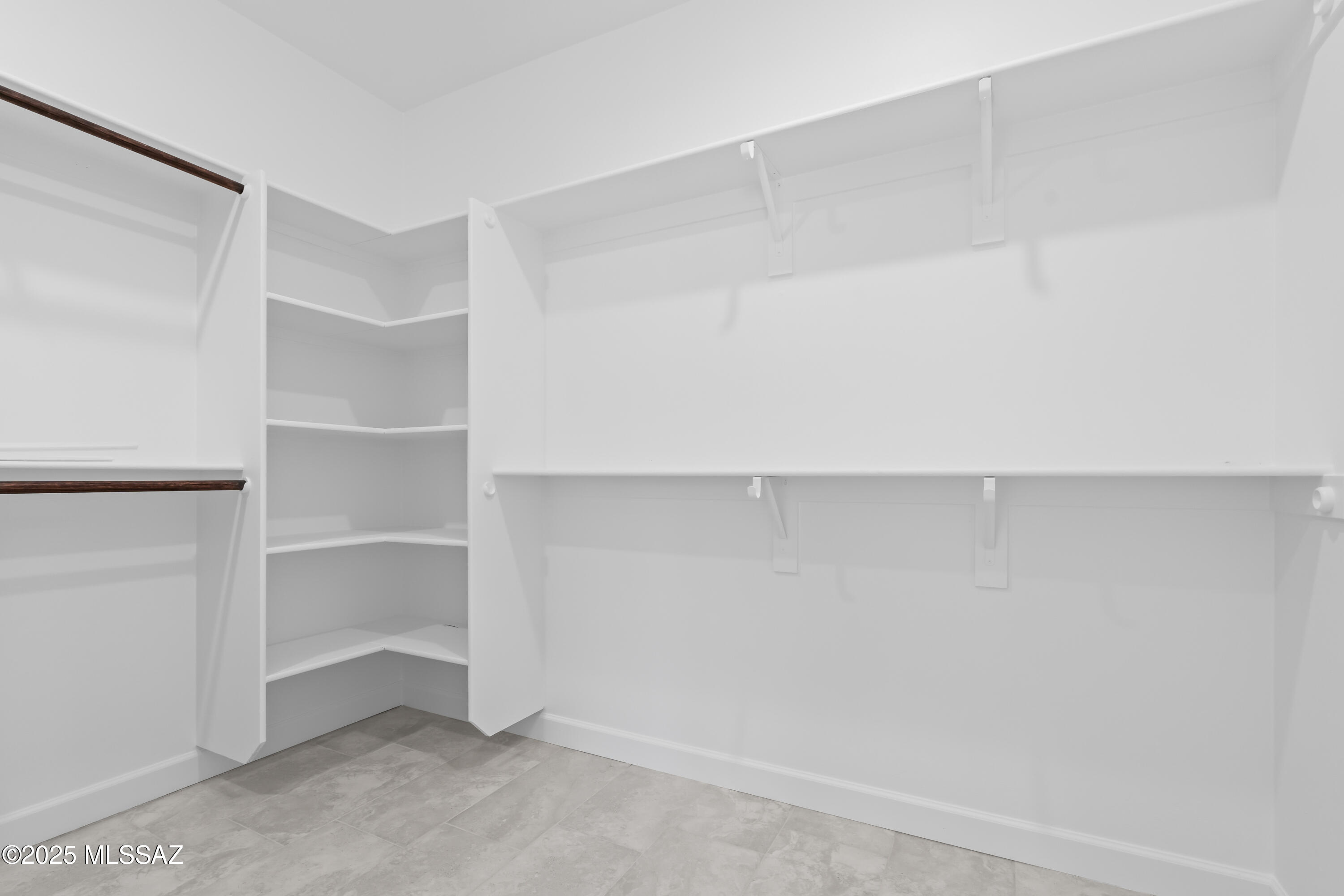 1667 Ave Calamar Rio Rico, AZ 85648 - Photo 21 of 33 a room with walk in closet with empty racks