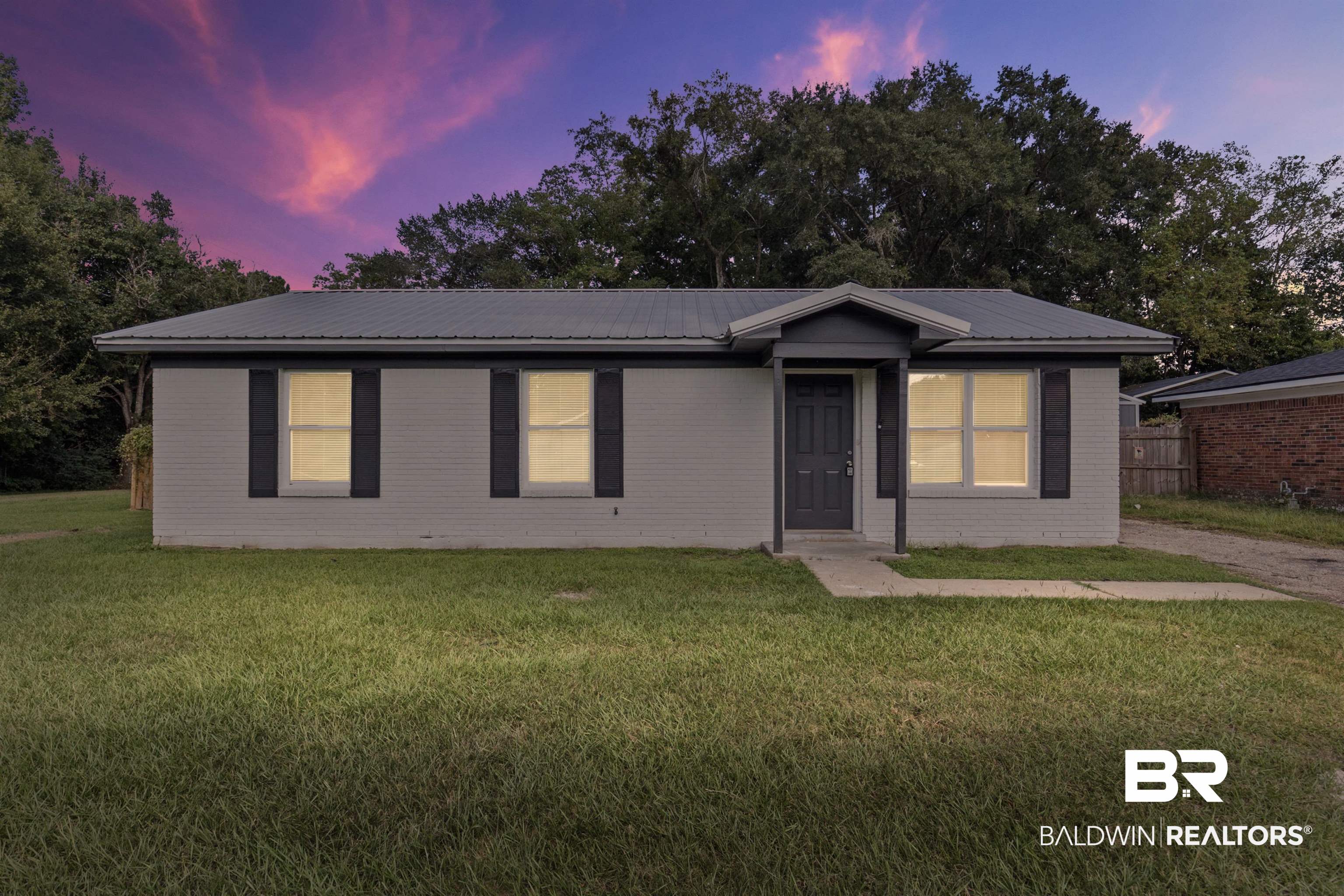 7795 Bellingrath Road Theodore, AL 36582 - Photo 2 of 18 Single story home with a front lawn, a metal roof, and brick siding