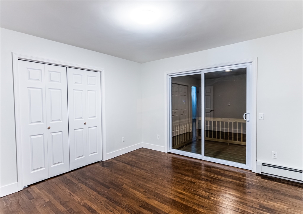 1560 West Main Road Middletown, RI 02842 - Photo 11 of 18 an empty room with wooden floor and windows