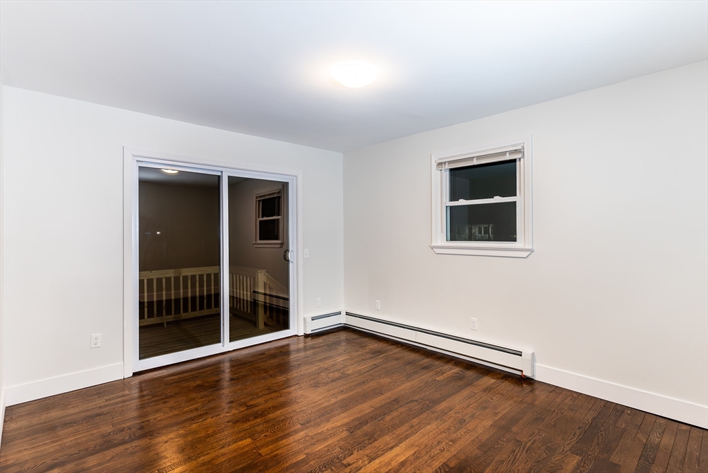 1560 West Main Road Middletown, RI 02842 - Photo 12 of 18 an empty room with wooden floor and windows