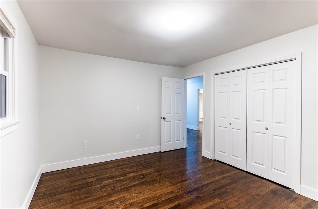 1560 West Main Road Middletown, RI 02842 - Photo 13 of 18 a view of an empty room with wooden floor