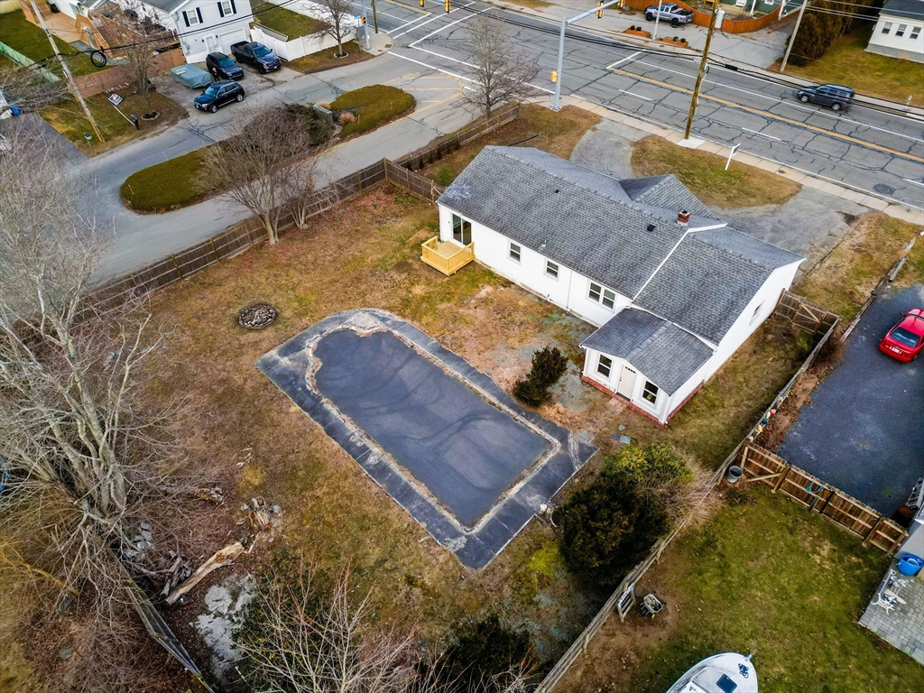 1560 West Main Road Middletown, RI 02842 - Photo 17 of 18 an aerial view of a house with a yard and wooden fence