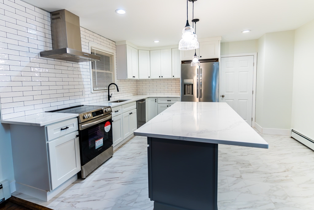 1560 West Main Road Middletown, RI 02842 - Photo 3 of 18 a kitchen with a stove a sink dishwasher and a refrigerator