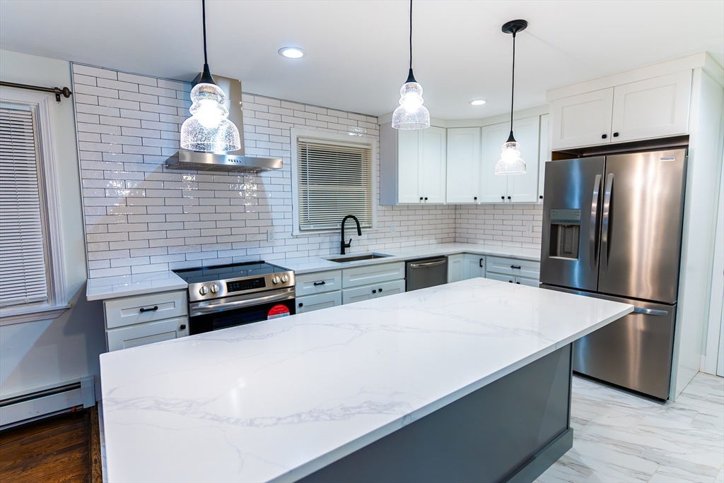 1560 West Main Road Middletown, RI 02842 - Photo 5 of 18 a kitchen with stainless steel appliances a stove a refrigerator a sink and a stove