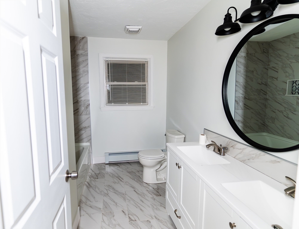 1560 West Main Road Middletown, RI 02842 - Photo 6 of 18 a bathroom with a sink and a mirror