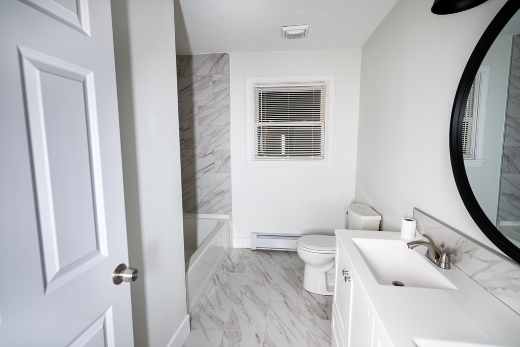 1560 West Main Road Middletown, RI 02842 - Photo 7 of 18 a bathroom with a sink toilet and shower