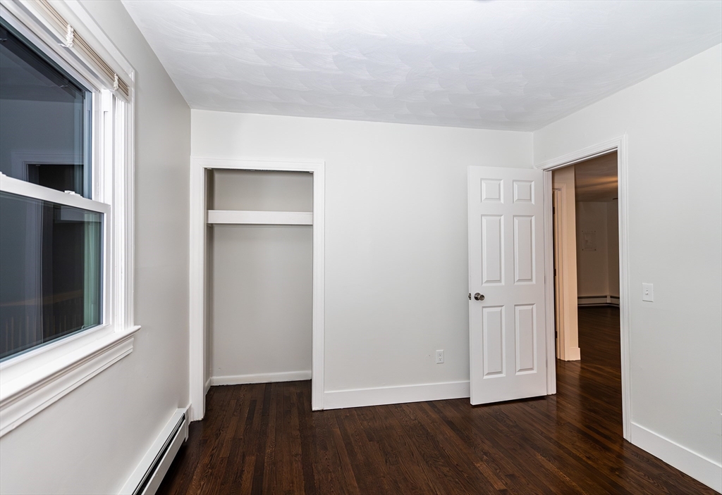 1560 West Main Road Middletown, RI 02842 - Photo 9 of 18 a view of an empty room with wooden floor and a window