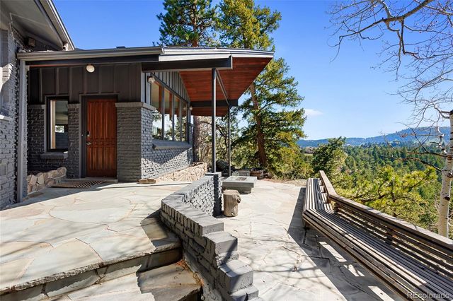 a view of a patio with table and chairs with wooden floor and fence