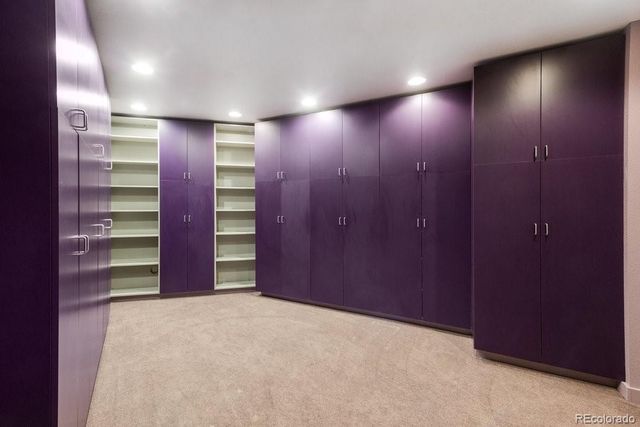 a view of an empty room with a closet and cabinet