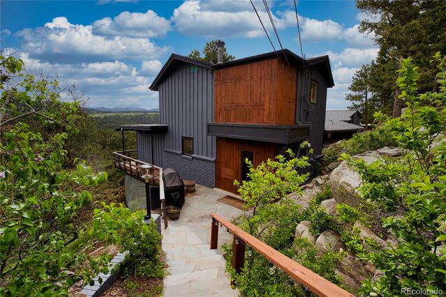 a view of a house with wooden fence
