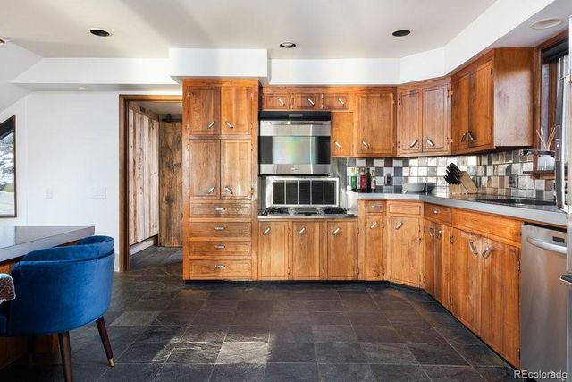 a kitchen with stainless steel appliances granite countertop a sink and cabinets