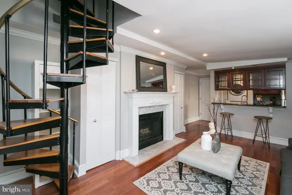 a living room with furniture a rug and a fireplace