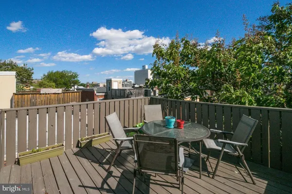 a view of balcony with wooden floor and outdoor seating