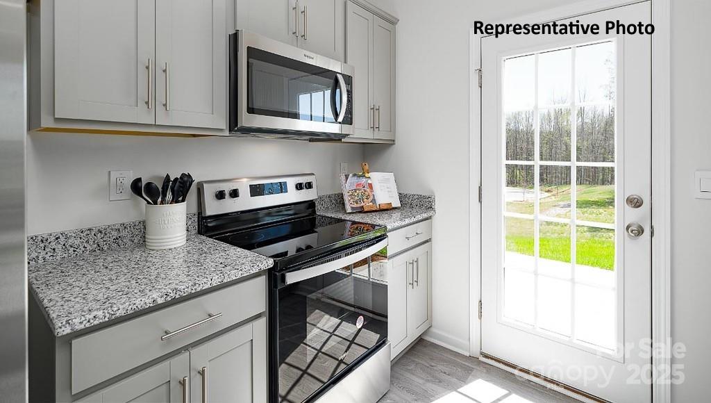 545 Trading Post Lane York, SC 29745 - Photo 9 of 25 a kitchen with stainless steel appliances granite countertop a sink stove and cabinets