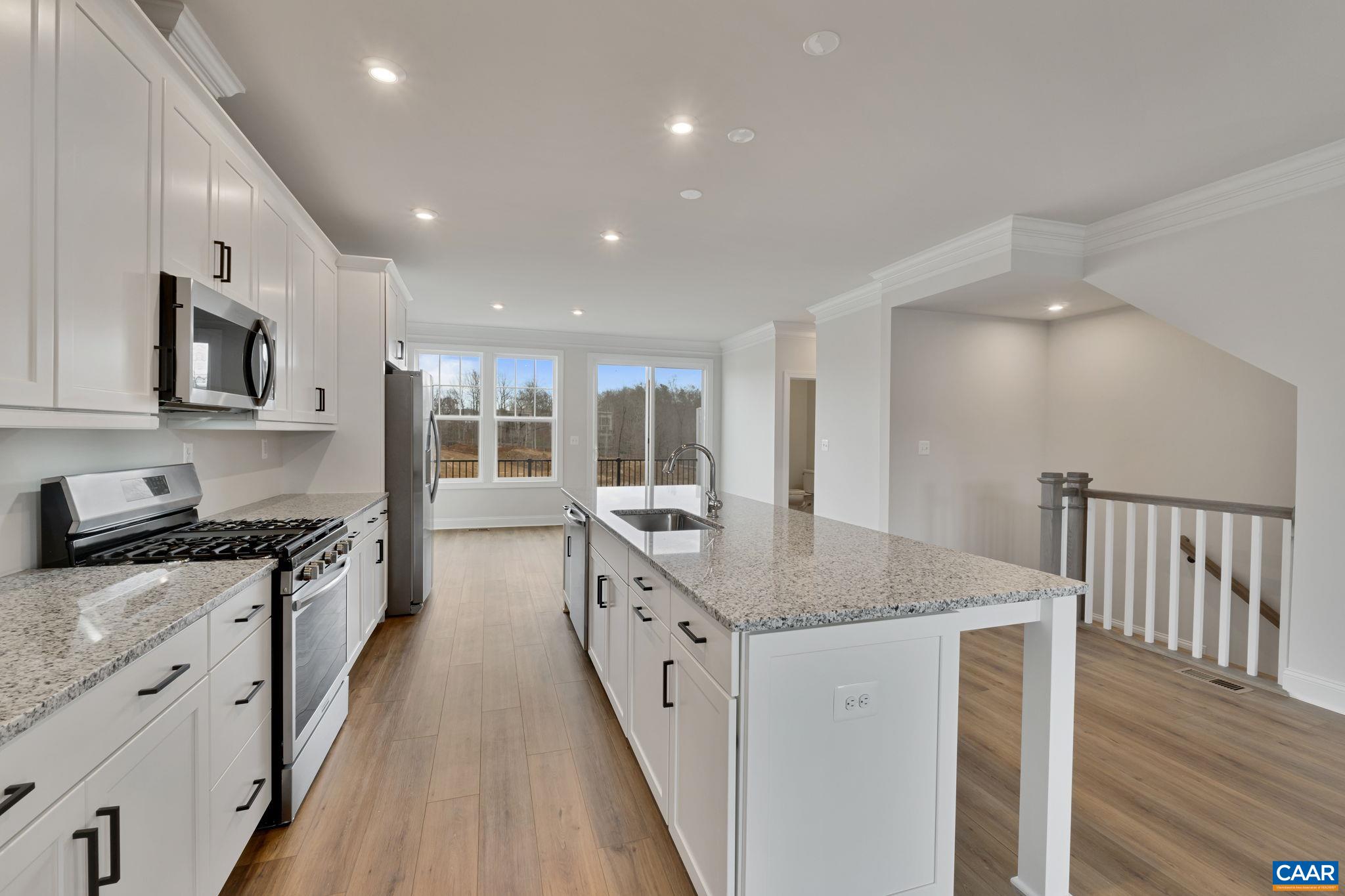 23 Talen Lane Charlottesville, VA 22911 - Photo 20 of 44 a kitchen with granite countertop a stove top oven a sink a counter space and cabinets