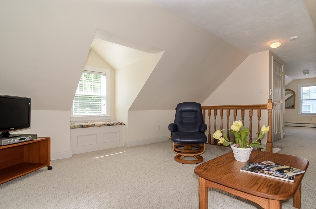15 Virginia Road Arlington, MA 02476 - Photo 15 of 21 a living room with furniture a flat screen tv and a window