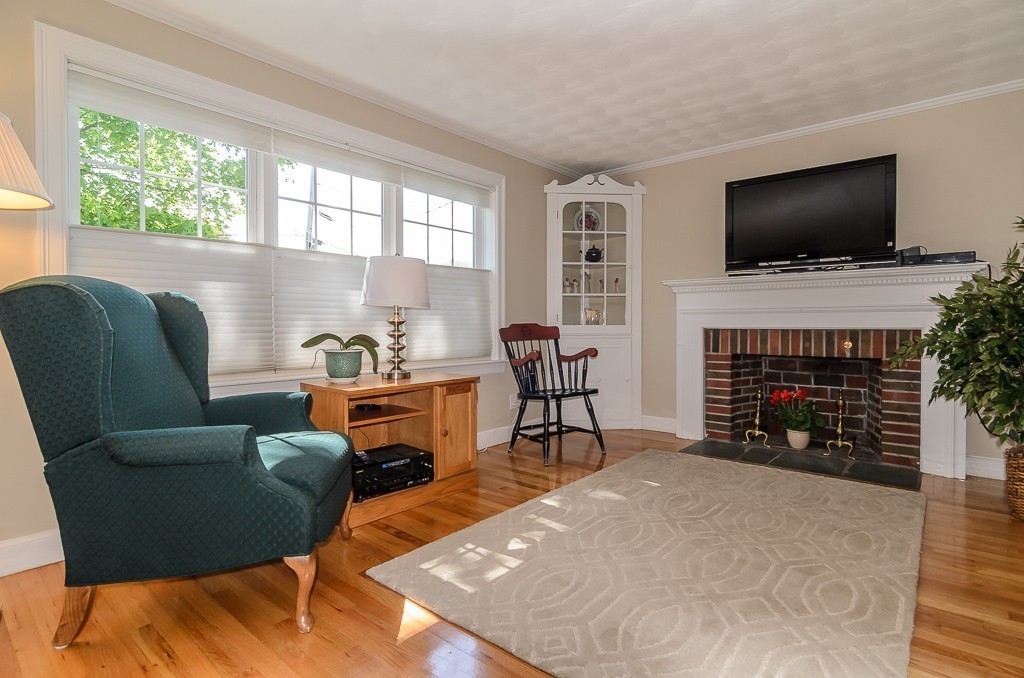 15 Virginia Road Arlington, MA 02476 - Photo 3 of 21 a living room with furniture a flat screen tv and a fireplace