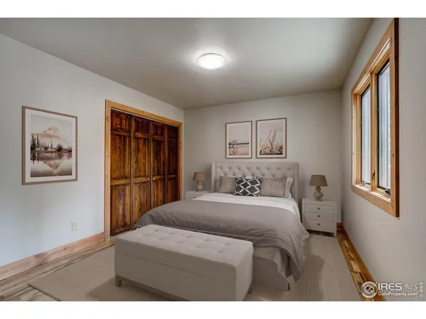 a bedroom with a bed and a painting on the wall