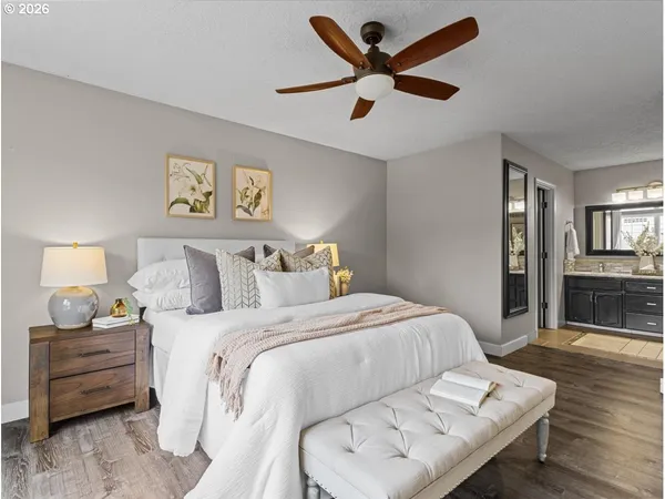 a bedroom with a bed and wooden floor