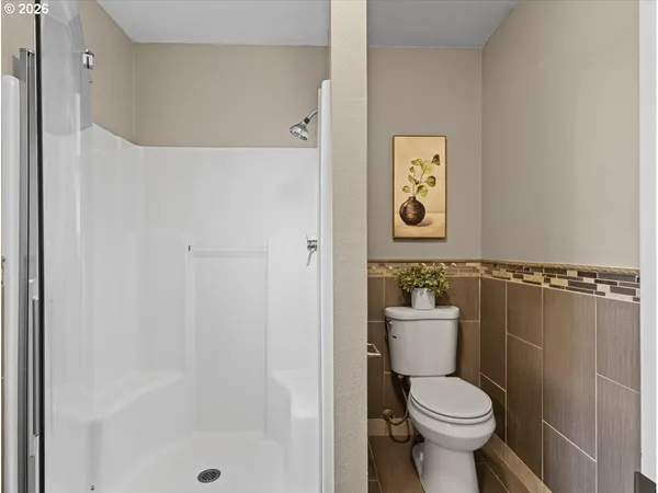 a bathroom with a toilet sink and shower