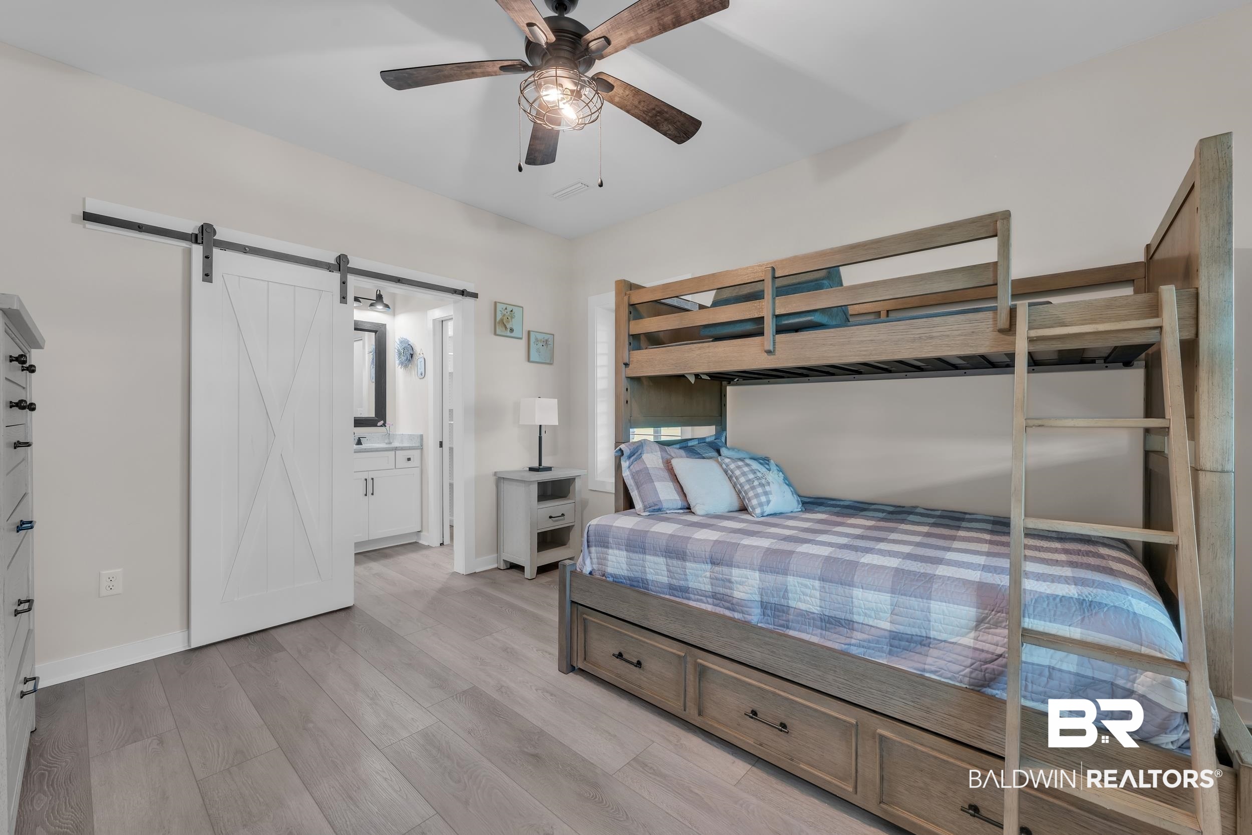 22592 Pastoral Lane Foley, AL 36535 - Photo 21 of 45 Bedroom featuring light wood finished floors, a barn door, ensuite bathroom, and ceiling fan