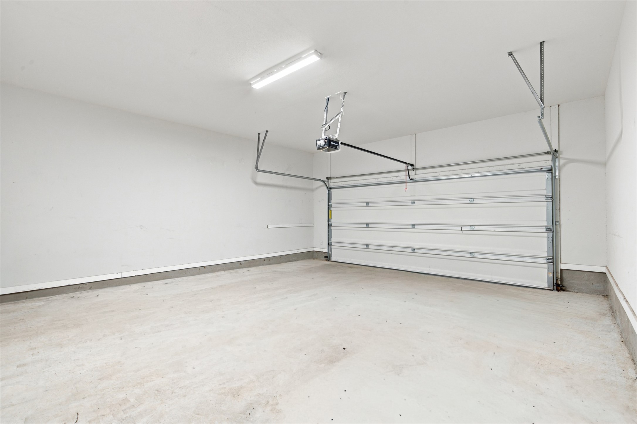 336 Berkeley Place Georgetown, TX 78628 - Photo 27 of 36 An attached two-car garage provides clean concrete flooring and overhead lighting.